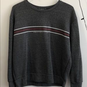 Gray wool sweater labeled “Female Revolution”